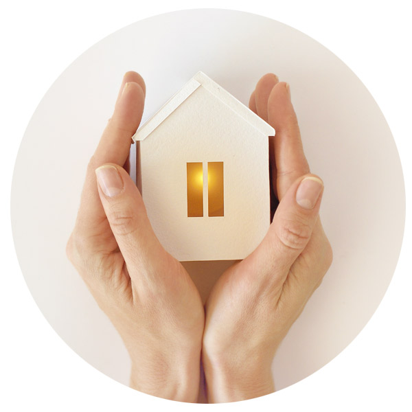 hands being warmed on miniature house